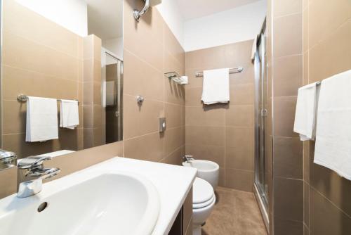 a bathroom with a sink and a toilet and a shower at Hotel Montestella in Salerno