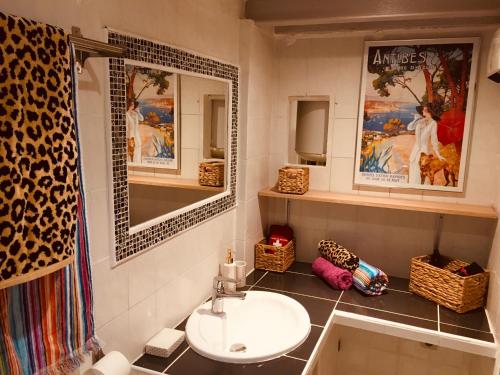 a bathroom with a sink and a mirror at Artistic Antibes Apartment in Antibes