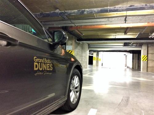 a black car parked in a parking garage at Grand Baltic Dunes Hotel & SPA in Palanga