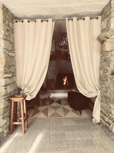 a living room with a curtain and a fireplace at Casa al Riccio in Capolona