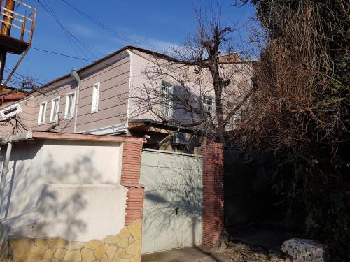 a house with a gate and a garage at Family Hotel Mountain Scream in Tbilisi City