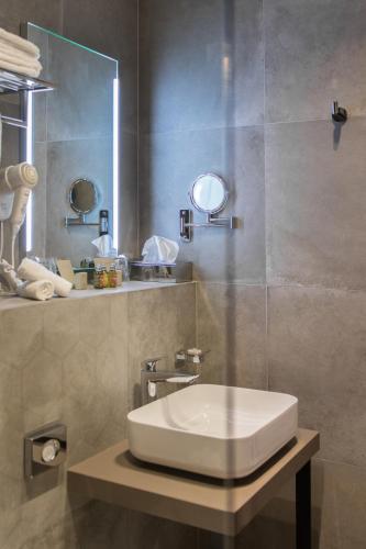 a bathroom with a sink and a mirror at Livris Hotel in Zagreb
