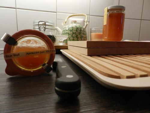 a kitchen counter with a cutting board and a knife at Blue Wall BnB in Gebenstorf