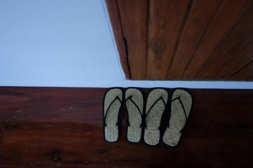a close up of the m on a wooden floor at Paiyannoi Guesthome in Chiang Mai