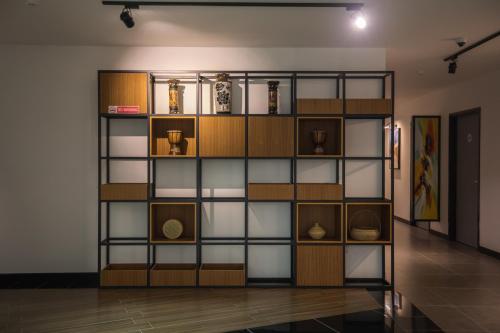 a book shelf in a room with vases on it at 3-Plus Hotel in Kota Kinabalu