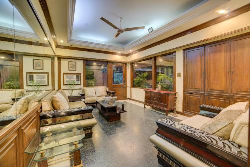 a living room with couches and a ceiling at Cp Villa - Rooms with Patio in New Delhi