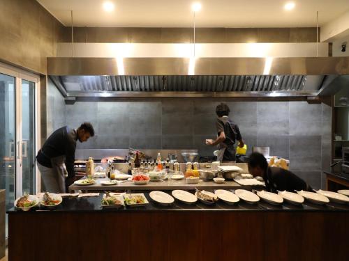 a group of people in a kitchen preparing food at Fresh Wave Mirissa - Beach Front in Mirissa
