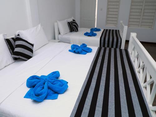 two beds with blue towels on top of them at Fresh Wave Mirissa - Beach Front in Mirissa