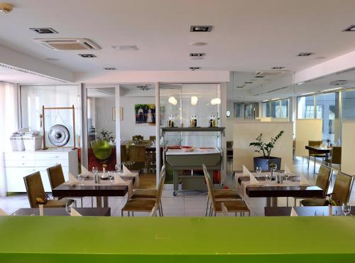 a dining room with tables and chairs in a restaurant at Hotel EMPIRE in Trnava