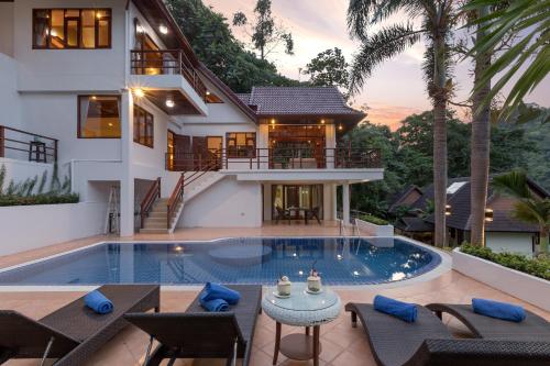 a villa with a swimming pool and a house at Patong Hill Estate 6 in Patong Beach
