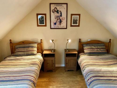 two beds sitting next to each other in a room at Dupres House, Chavasse Farm, Somme Battlefields in Hardecourt-aux-Bois