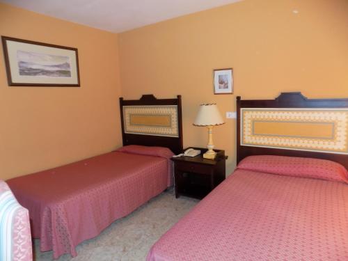 Tempat tidur dalam kamar di Hotel La Barca