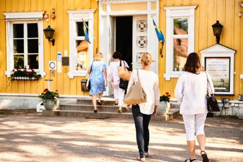 a group of women walking into a yellow building at Knistad Herrgård in Skövde