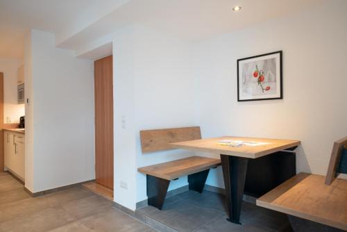 a table and a bench in a room at Stadlchalet in Ried im Oberinntal