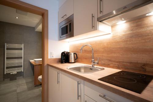 a kitchen with a sink and a microwave at Stadlchalet in Ried im Oberinntal