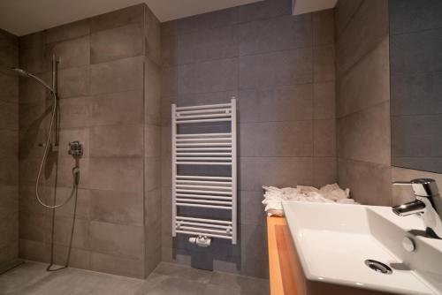 a bathroom with a sink and a shower at Stadlchalet in Ried im Oberinntal