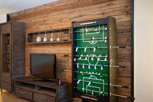 a television in a room with a wall at Stadlchalet in Ried im Oberinntal