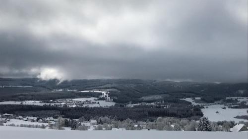 a view of a town in the snow on a mountain at Hotel Sternen in Lenzkirch