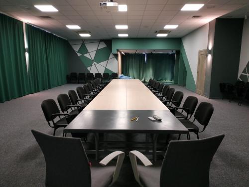 a conference room with a long table and chairs at Aquadar in Manʼkivka