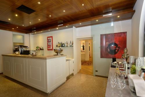 a restaurant with a counter in a room at Hotel Canon d'Oro in Conegliano