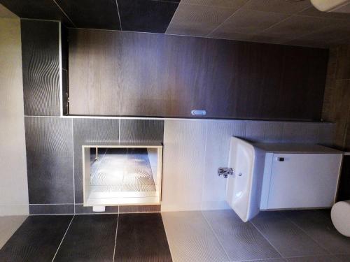 a bathroom with a fire place in the wall at Apartmani Berno in Starigrad