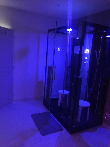 Zimmer mit zwei Hockern in einem Zimmer mit blauen Lichtern in der Unterkunft Dreamspa in Audincourt