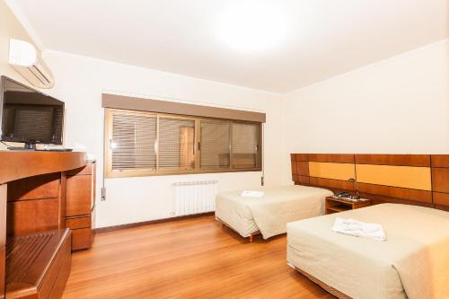 Ένα ή περισσότερα κρεβάτια σε δωμάτιο στο Hotel Letto Caxias