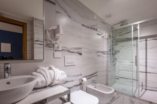 a bathroom with a sink and a toilet and a shower at Hotel Canon d'Oro in Conegliano