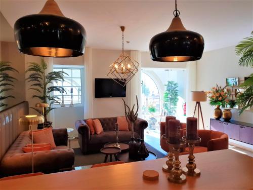 a living room with couches and a table at Quinta da Palmeira - Country House Retreat & Spa in Cerdeira