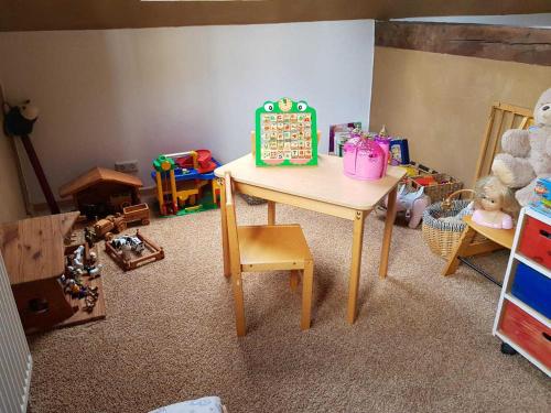 a childs room with a table with a chalkboard on it at Haus Nr. 9 in Ruppichteroth