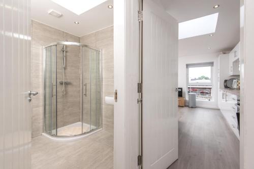 a bathroom with a shower with a glass door at The Gem in Armagh