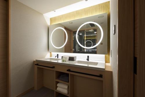a bathroom with a sink and a mirror at HOTEL 1899 TOKYO in Tokyo