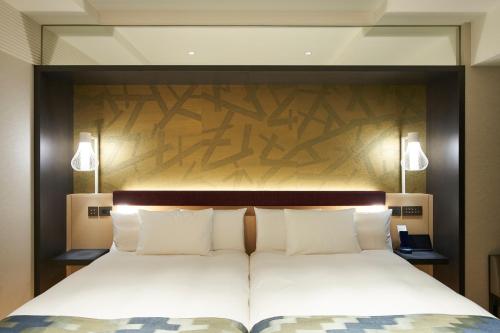 a bedroom with a large bed with a wooden headboard at HOTEL 1899 TOKYO in Tokyo