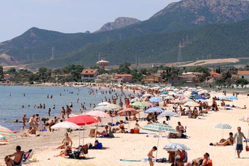 カポテッラにあるCasa Vacanza Appartamenti Al Mareの傘持ちの浜辺の人々