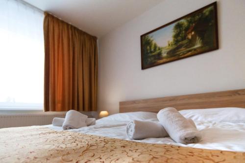 a bedroom with a bed with towels on it at Hotel Lesana in Vysoké Tatry