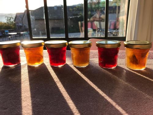 a group of four glasses of beer sitting on a table at Chambres d'hôtes Vers la Croix in Leynes