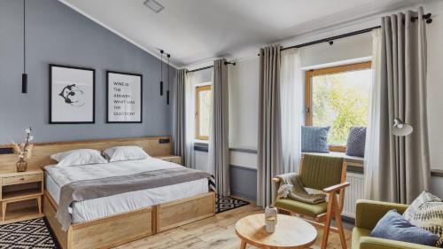 a bedroom with a bed and a chair and a table at Wine&Pillow Hotel by Frapolli in Odesa