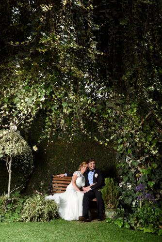 a bride and groom sitting on a bench at Hotel Casagrande in Arequipa