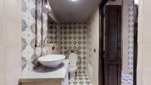 a bathroom with a sink and a toilet at ferme by Ikalimo in Ourika