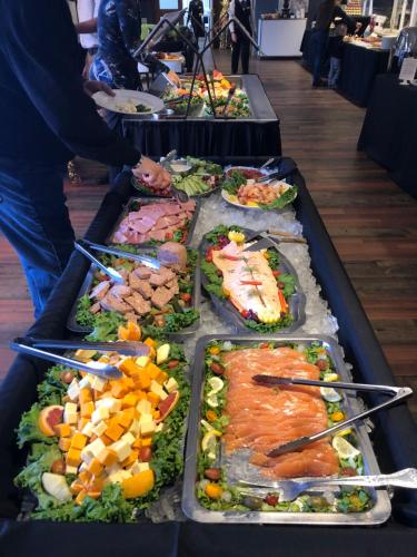 a buffet of different types of food in trays at Auberge des Gallant in Rigaud