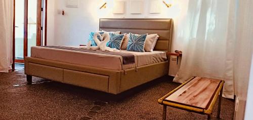 a bed with pillows and a table in a room at White Chocolate Hills Resort in Zamboanguita