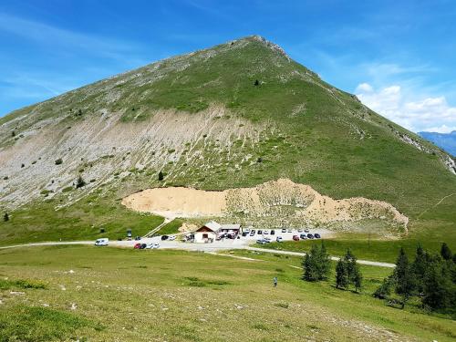 a mountain with a building on the side of it at Le p'tit Cozy in Le Dévoluy