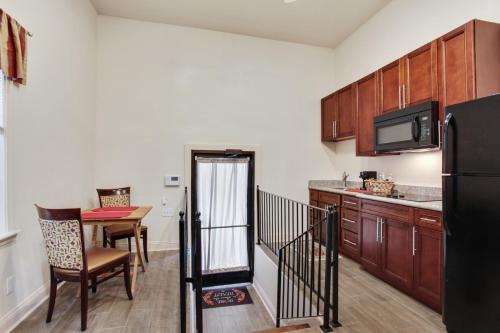 a small kitchen with a table and a refrigerator at N Broad Studios in New Orleans