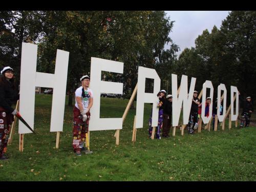 a group of people standing in front of a sign at Hotel Hermica in Tampere