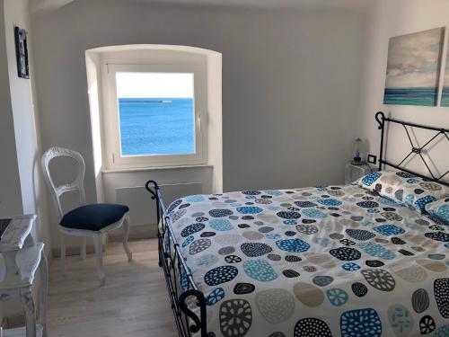 a bedroom with a bed and a window at La Casetta di Dory sul Mare in Genova