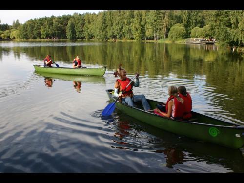a group of people in boats on a lake at Hotel Hermica in Tampere
