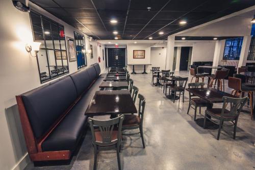 a row of tables and chairs in a restaurant at enVision Hotel Miami International Airport in Miami