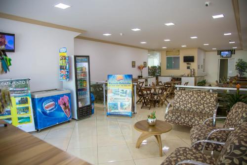 a waiting room with chairs and machines in a restaurant at Pousada Belezinha in Arraial do Cabo