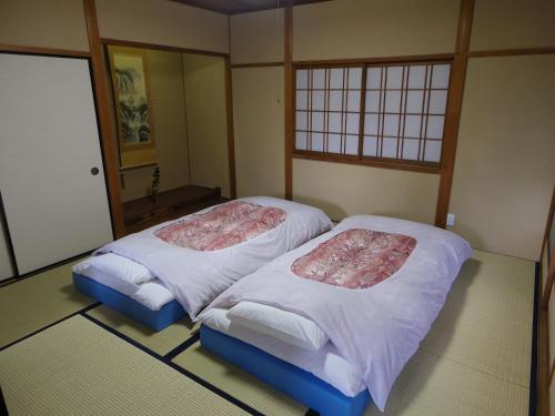 Кровать или кровати в номере Guest House Motomiya
