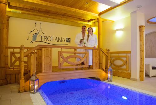 a man standing in front of a swimming pool at Trofana Wellness & SPA in Międzyzdroje